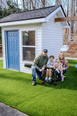 Owen and family showing off his new swing and clubhouse