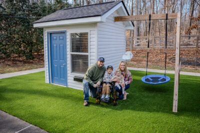 Owen and family showing off his new swing and clubhouse