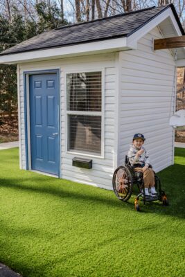 Owen in front of his new clubhouse