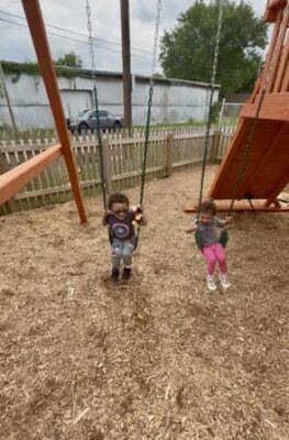 Thomas and baby sister having a swing on his new playset